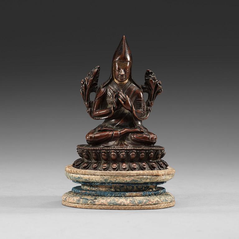 A copper alloy seated figure of a Tsong Khapa, presumably Nepal, 19th Century or older.