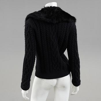 A black knitted cashmere cardiganwith fur collar by Ralph Lauren.