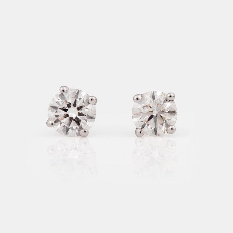 A pair of brilliant-cut diamond, circa H/VVS, studs.