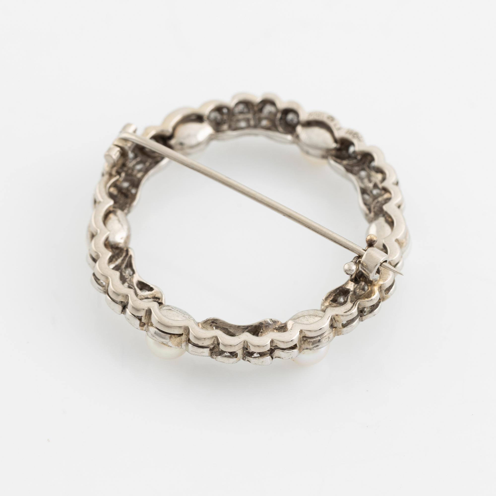 An 18K white gold ring set with cultured pearls and eight- and rose-cut diamonds.