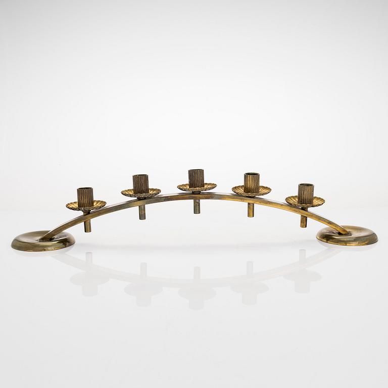 A mid-20th century brass candle holder, Idman.