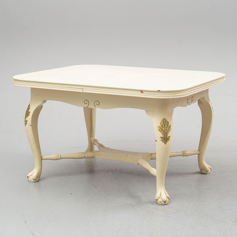 A dining table and six chairs, rococo style, mid 20th century.