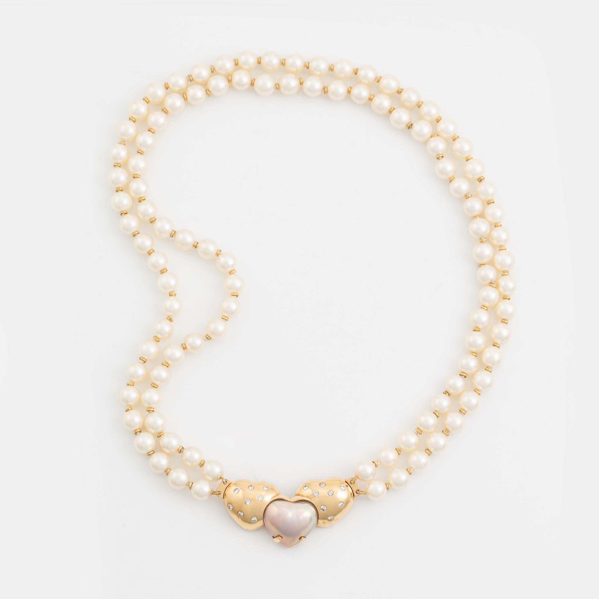 A two strand cultured pearl necklace with an 18K gold clasp with a half-pearl and round brilliant-cut diamonds.