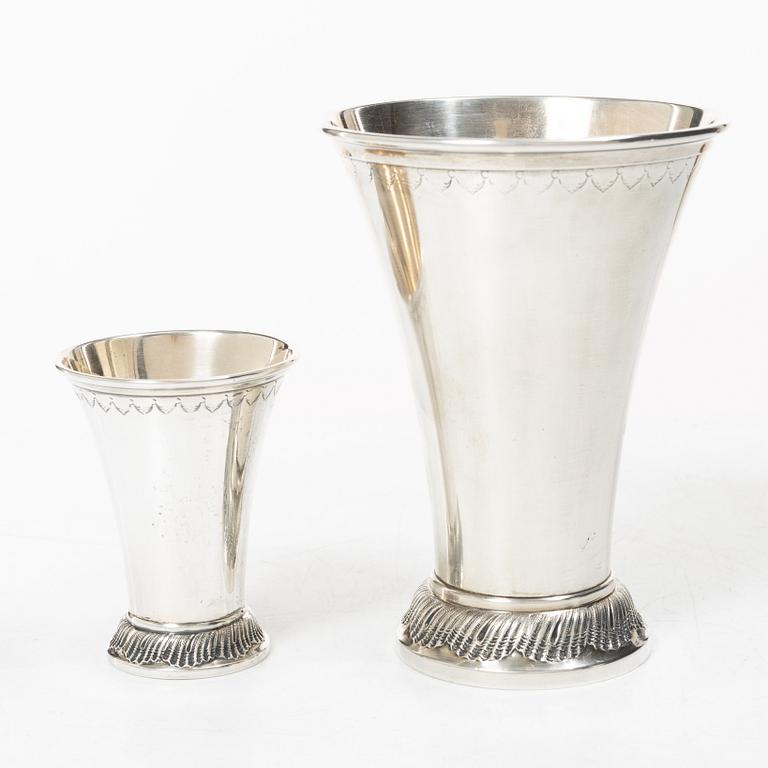 Two silver beakers and a bowl,