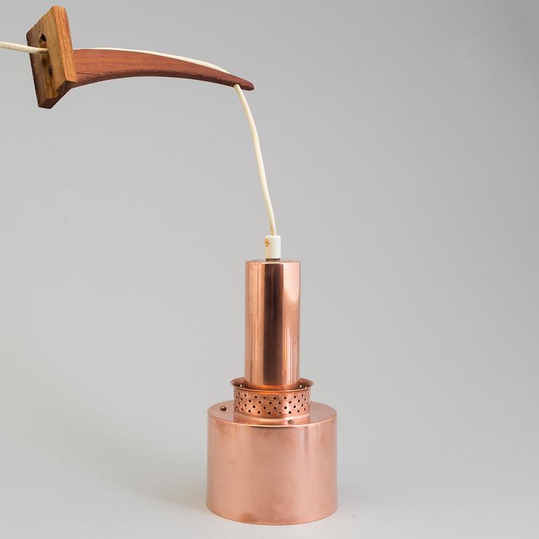 A 20th century ceiling light pendant in copper and wood.