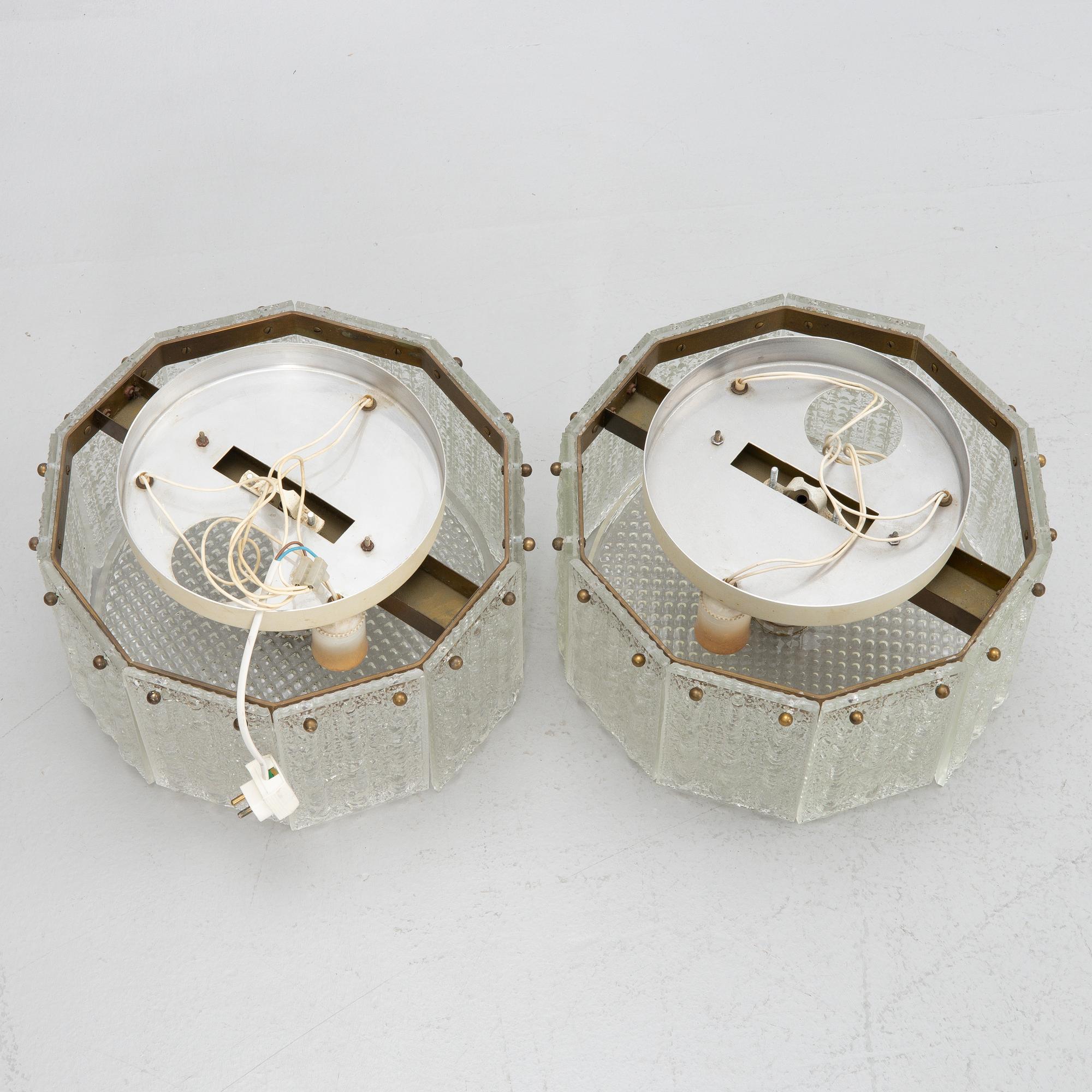 Carl Fagerlund, a pair of glass and brass ceiling lamps, Sweden, second half of the 20th century.