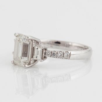 A RING set with an emerald-cut diamond.