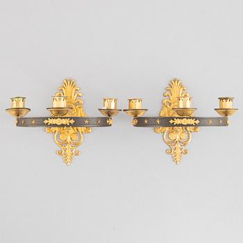 A pair of French Empire-style ormolu and patined bronze three-branch appliques, late 19th century.