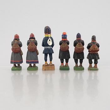 Five carved figurines by Lars Enarsson and one by Georg Jonsson, three leather pouches.