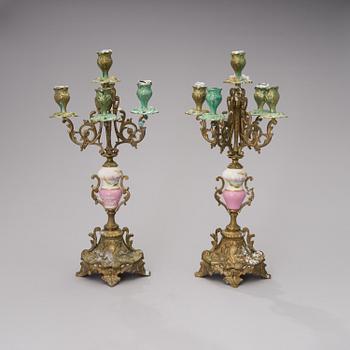 A pair of gilt-bronze Rococo Revival candelabra with porcelain decors, from the latter half of the 19th century.