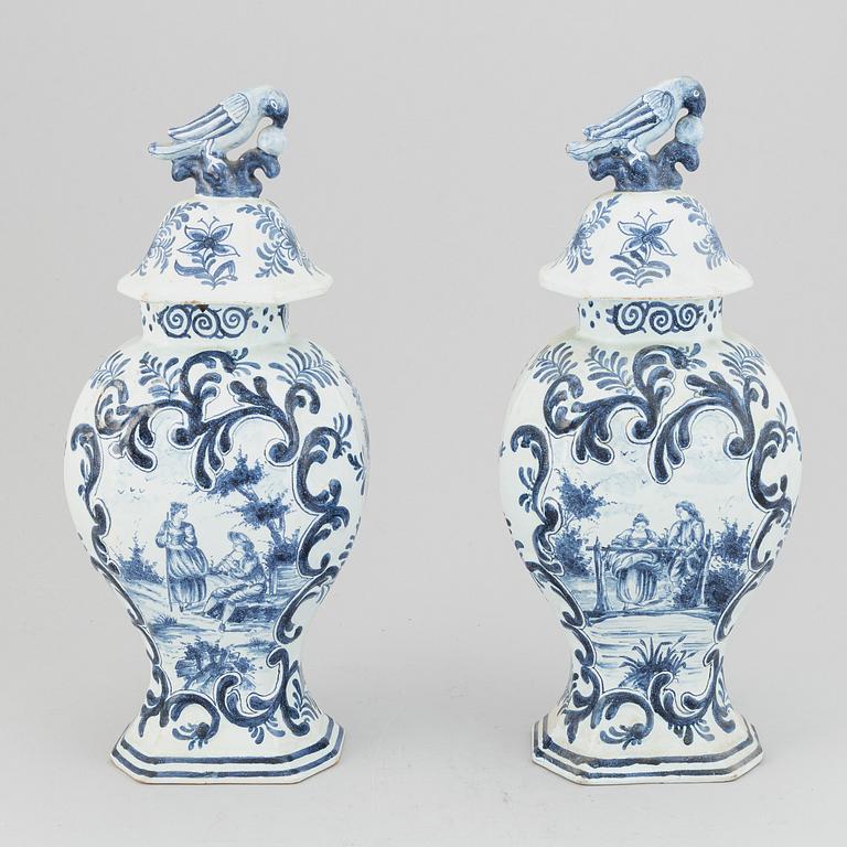 A pair of 19th century blue/white faience lidded jars, probably Dutch.