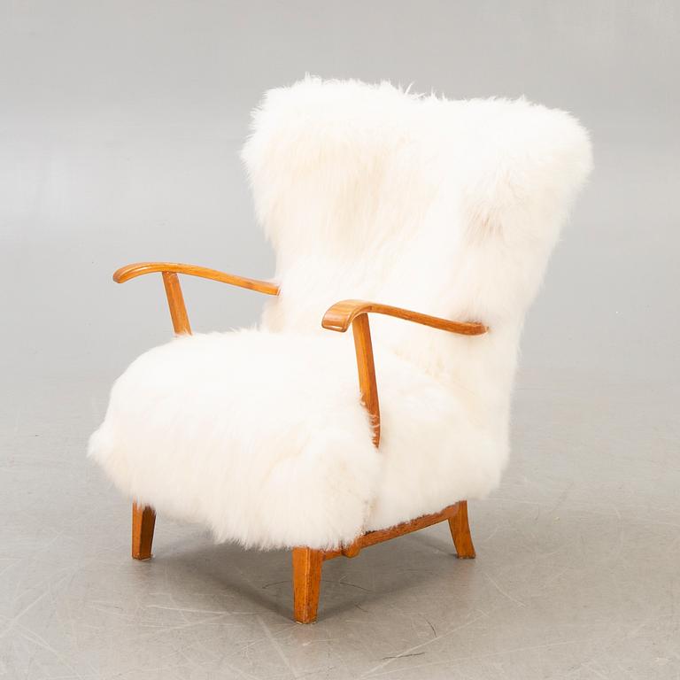 A 1940s sheepskin armchair.