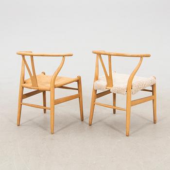 Hans J. Wegner, chairs, a pair of "The Wishbone Chair", model CH-24, Carl Hansen & Søn, Denmark.