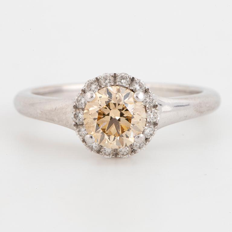 Yellow brilliant-cut diamond and brilliant-cut diamond cluster ring.