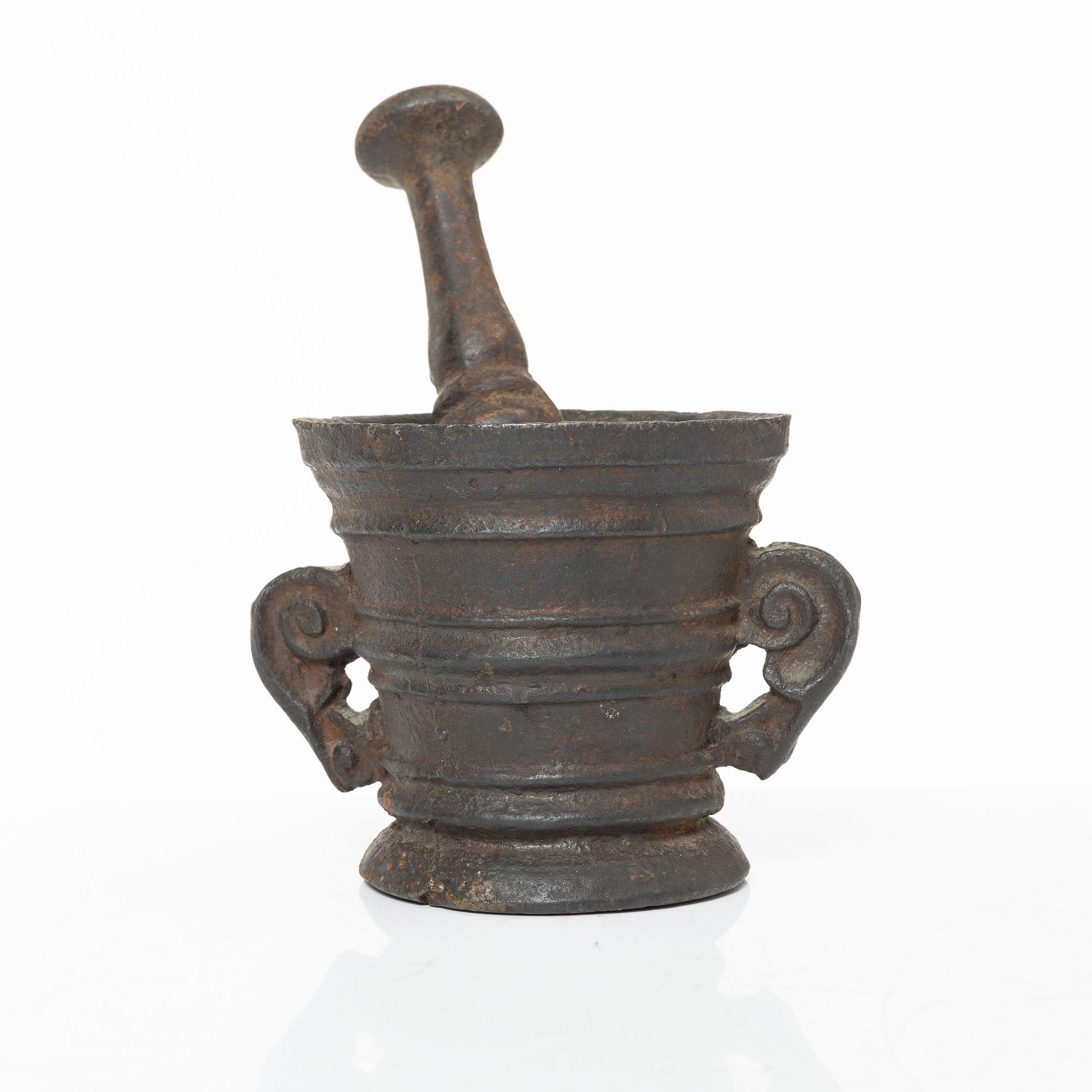 A cast-iron mortar and pestle of renaissance-type, 17th century.