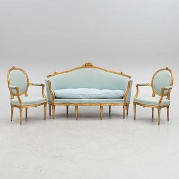 A sofa and a pair of chairs, Louis XVI style, circa 1900.