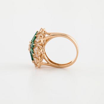An marquise cut emerald and brilliant cut diamond ring.