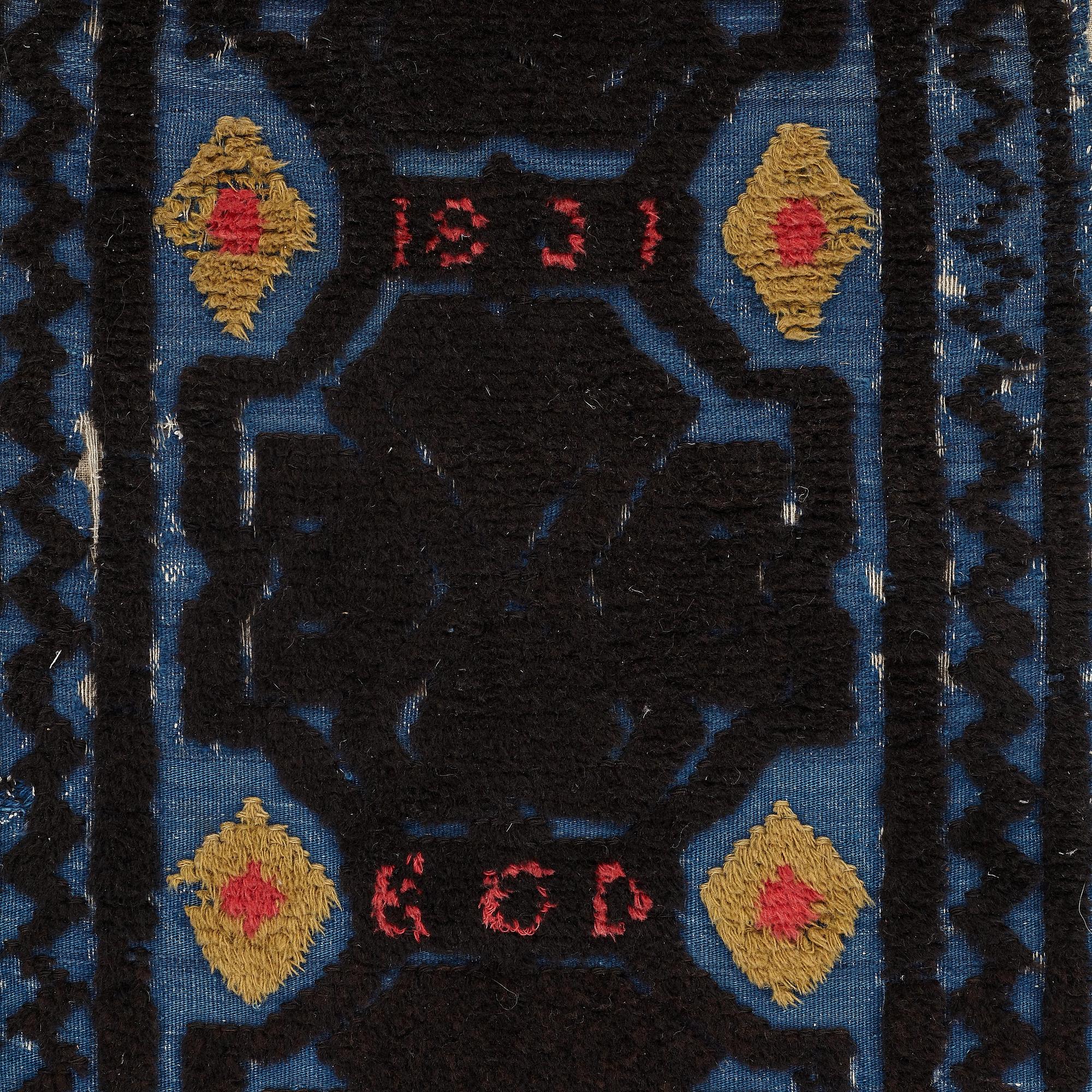 A carrige cushion, knotted pile in relief, ca 46,5 x 101 cm (with mounting 51 x 103,5 cm), probably Bara district,