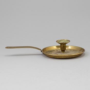 A brass candlestick, 19th century.