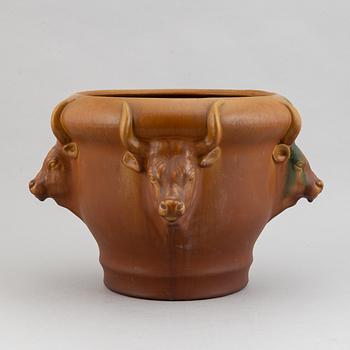 An earthenware pot decorated with four bulls heads. Probably by Karl Hansen Reistrup for Herman Kähler. Around 1900.