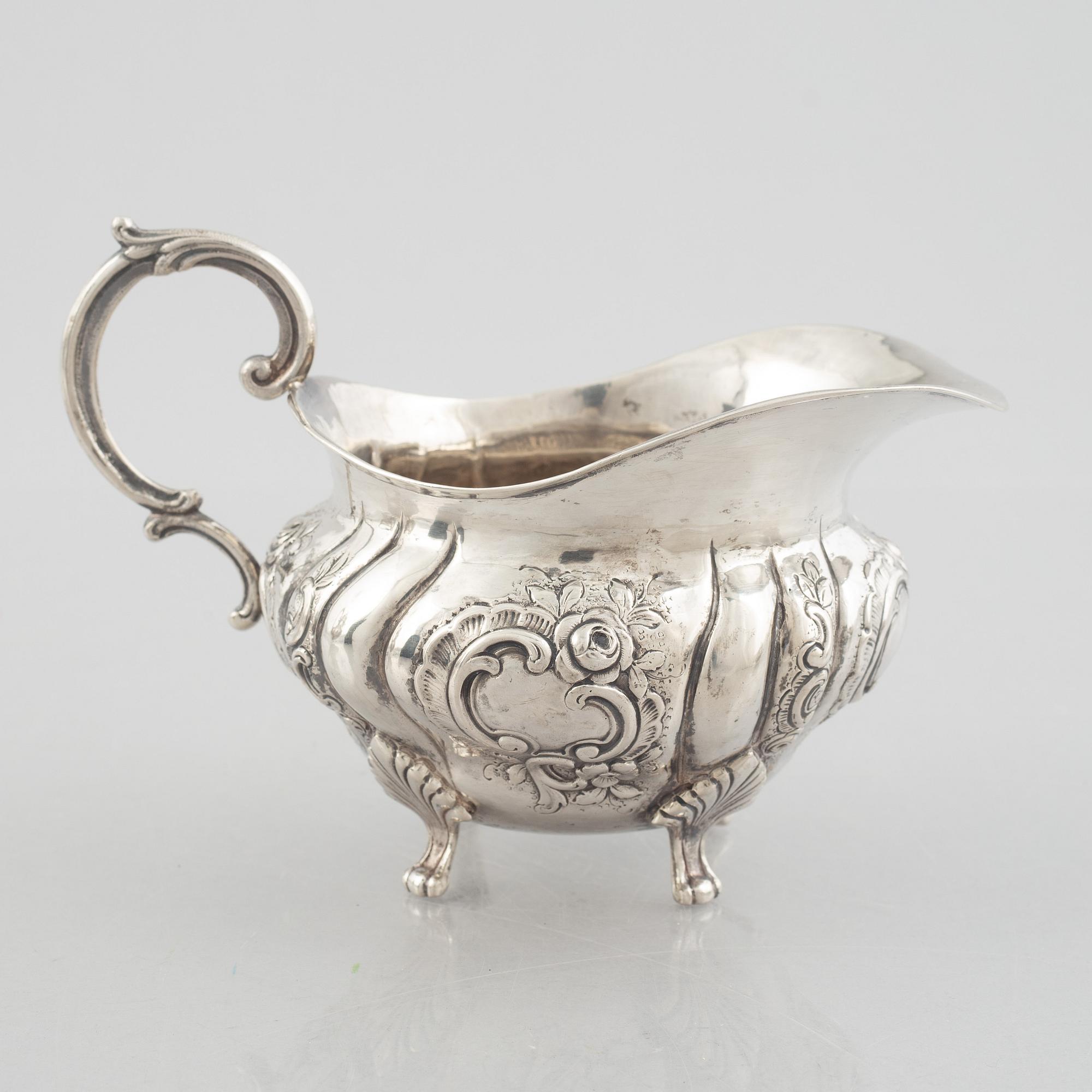 A Rococo-style silver coffee pot, creamer and sugar bowl, 20th Century.