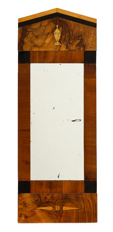 A mahogany-veneered Empire mirror, mid 19th century.