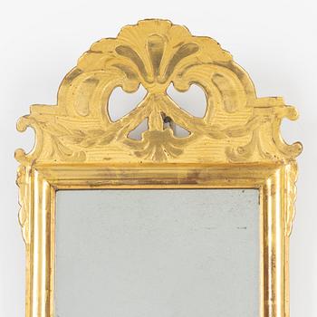 A giltwood rococo mirror by J. Schürer (master in Stockholm 1769).