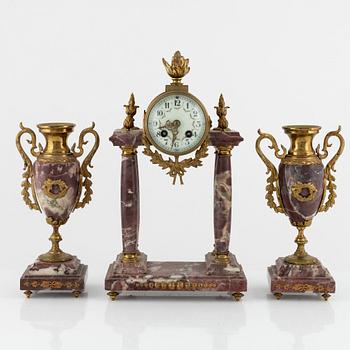 A Louis XVI-style Mantle Clock and a pair of decorative urns, early 20th Century.