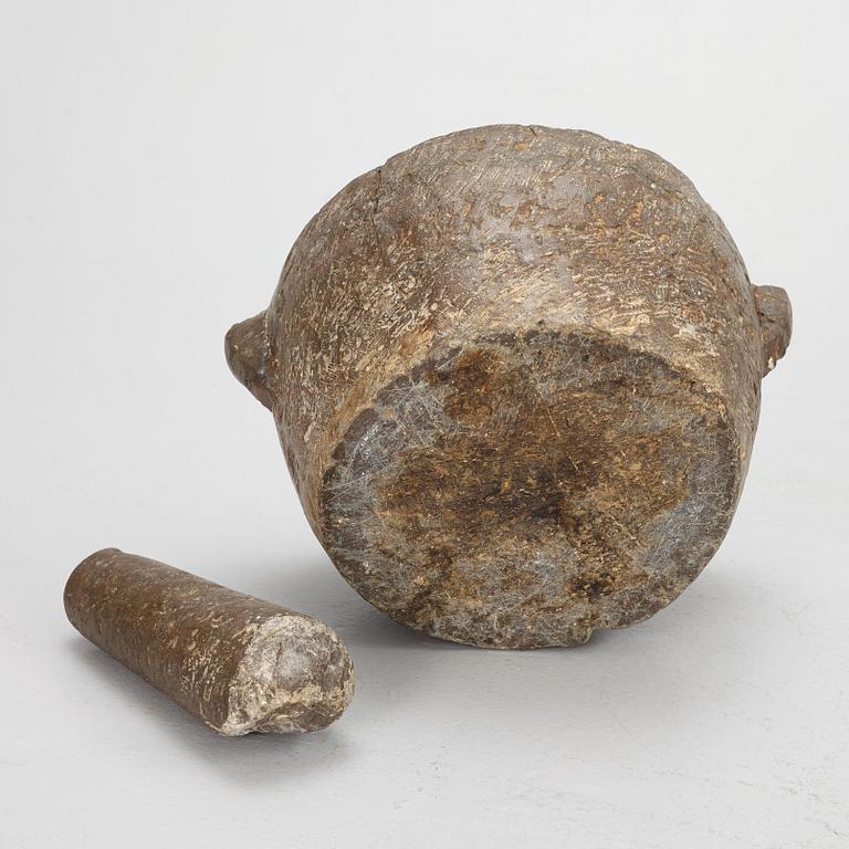 A llimestone mortar and pestle, 18th/19th Century.