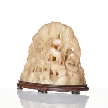 A carved Chinese soapstone bolder with Wang Mu's eight horses, 20th Century.