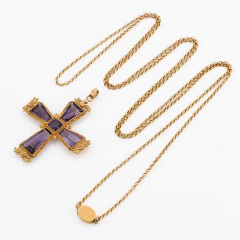An 18K gold cross with amethysts with a 23K gold chain.