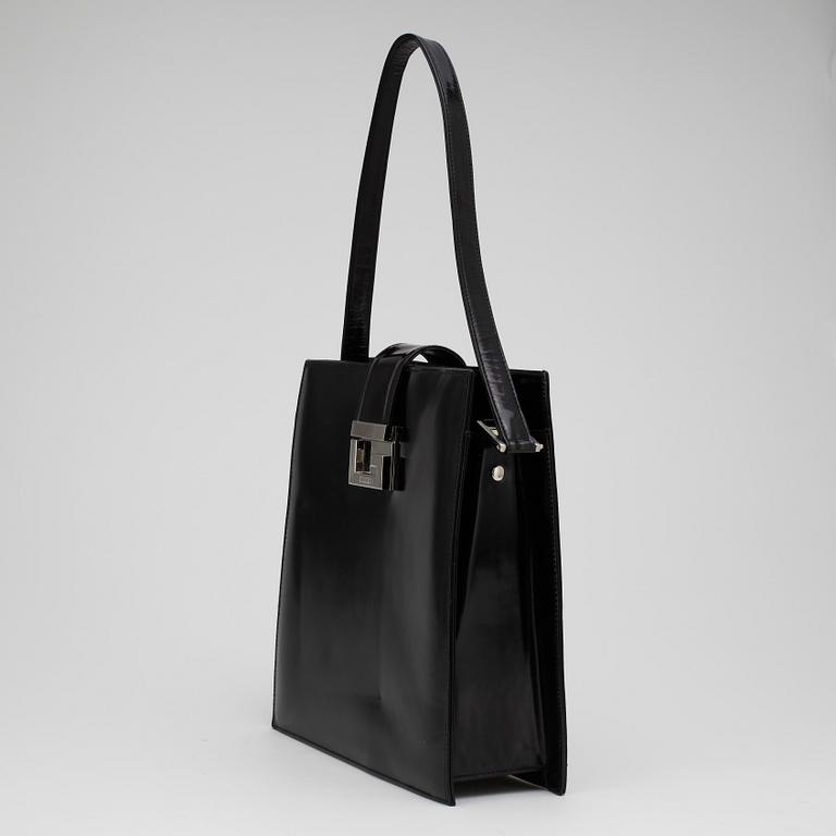 GUCCI, a black patent leather handbag.