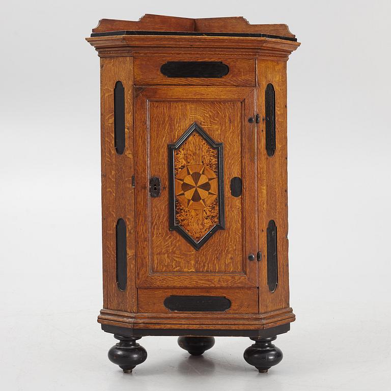 A Baroque corner cabinet, 18th Century.