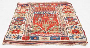 An antique Anatolian rug, c 136-147 x 104 cm (including flat weave).