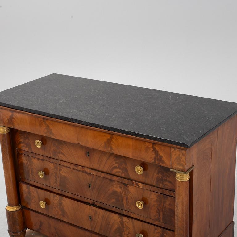 A French Empire mahogany and gilt brass mounted commode, early 19th century.