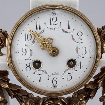 A French mantlepiece clock and a pair of candelabras, first half of the 20th century.