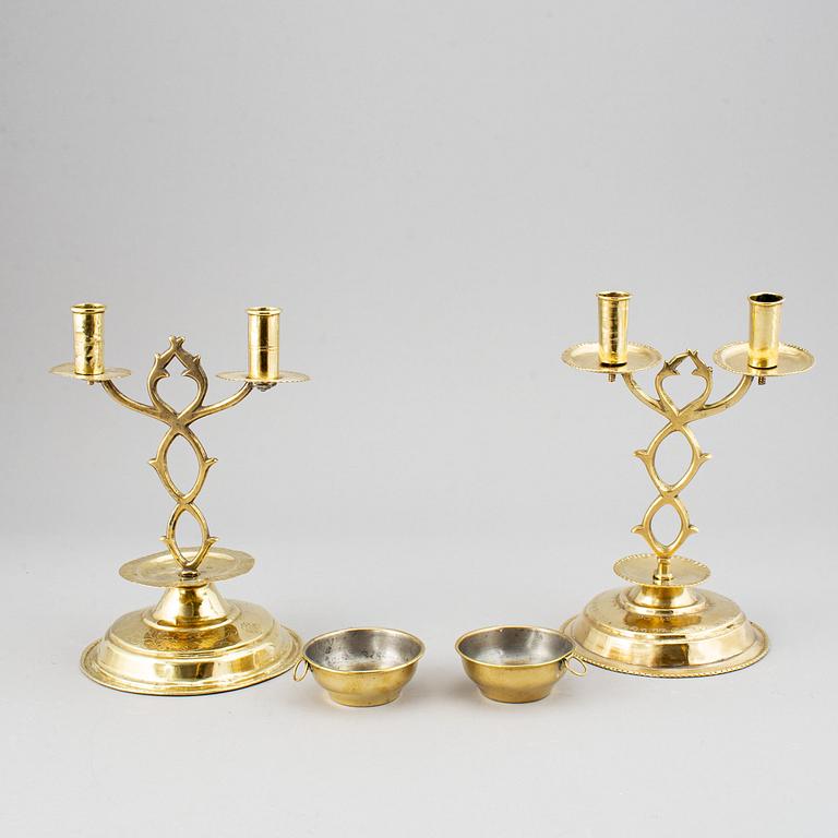 A pair of brass candelabra for two candles "Blekingestakar and a pair of brass cups, 1800/1900.