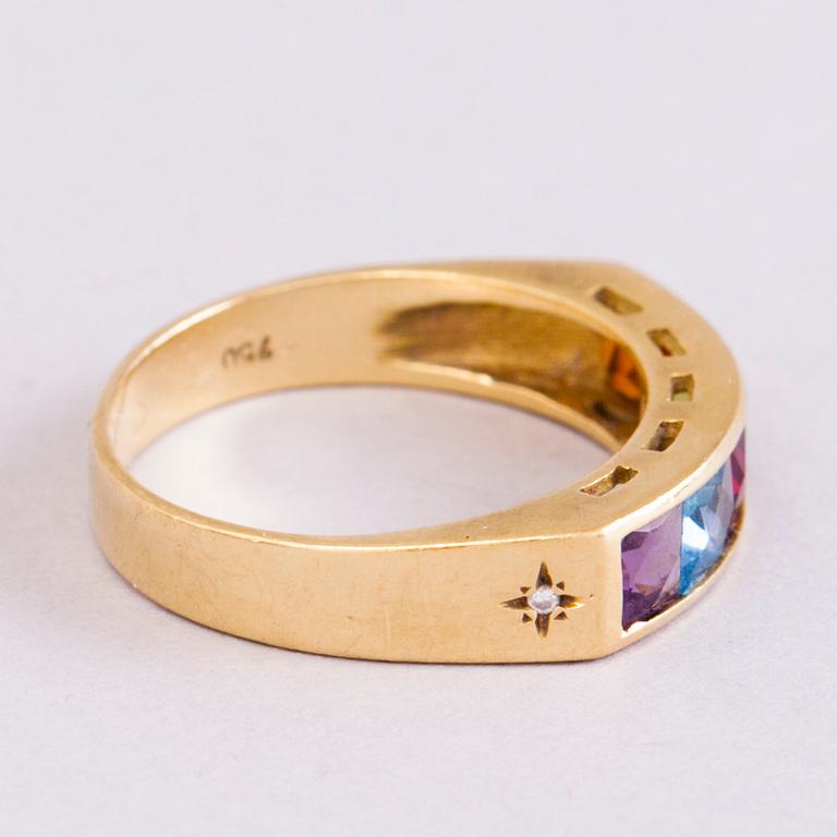 A 18K gold ring with 5 different stones: citrine, amethyst, topaz, garnet, peridot and a small diamond. Probably H.Stern.