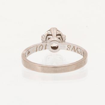 An 18K white gold solitaire ring set with a round brilliant cut diamond.