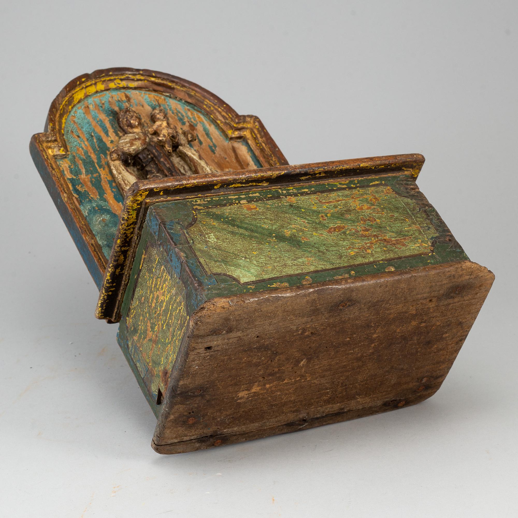 A painted wood alms box, probably 17th century.