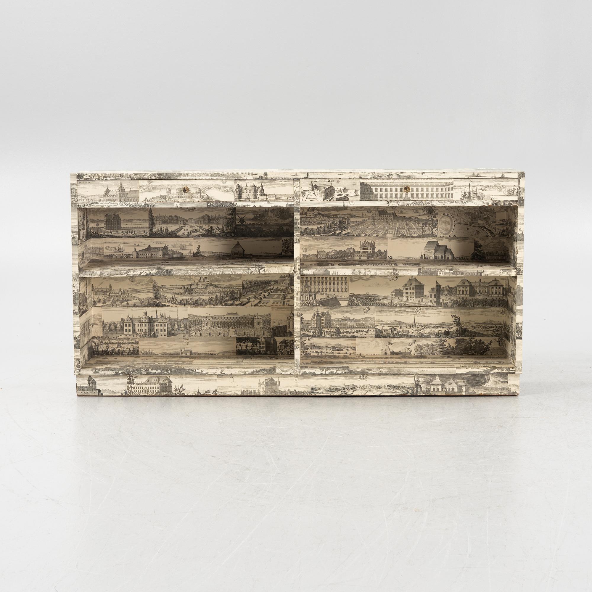 A bookcase decorated in prints from Dahlbergs Suecia antiqua et hodierna, mid 20th century.