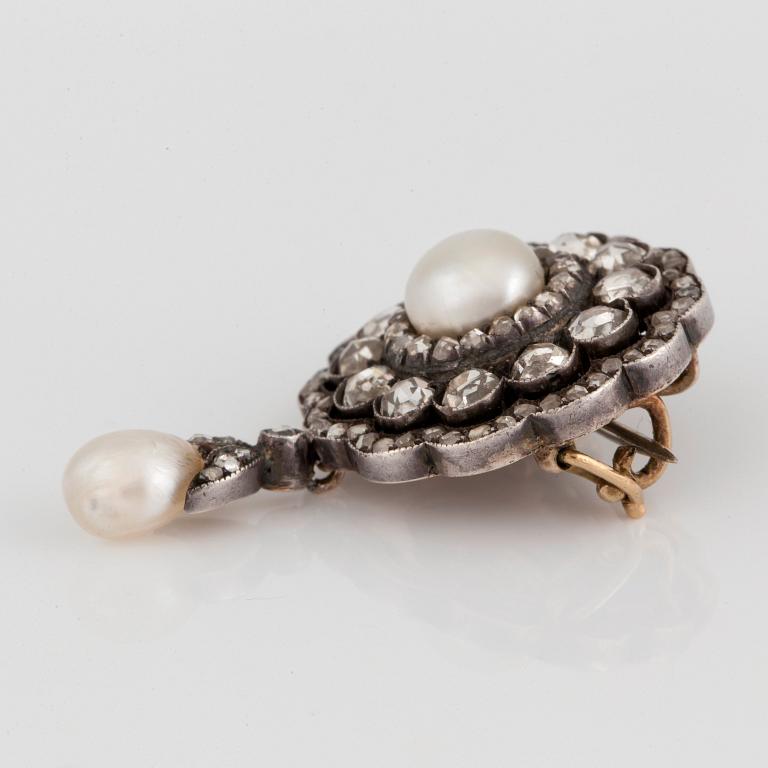 A brooch/pendant with a bouton shaped pearl and a drop shaped pearl and rose-cut diamonds.