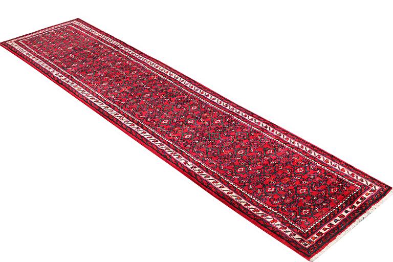 An oriental carpet, c. 395 x 87 cm.