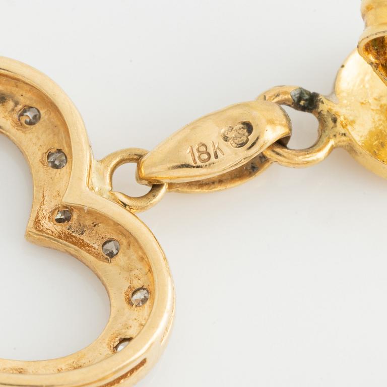 Earrings with hearts and small octagon-cut diamonds.