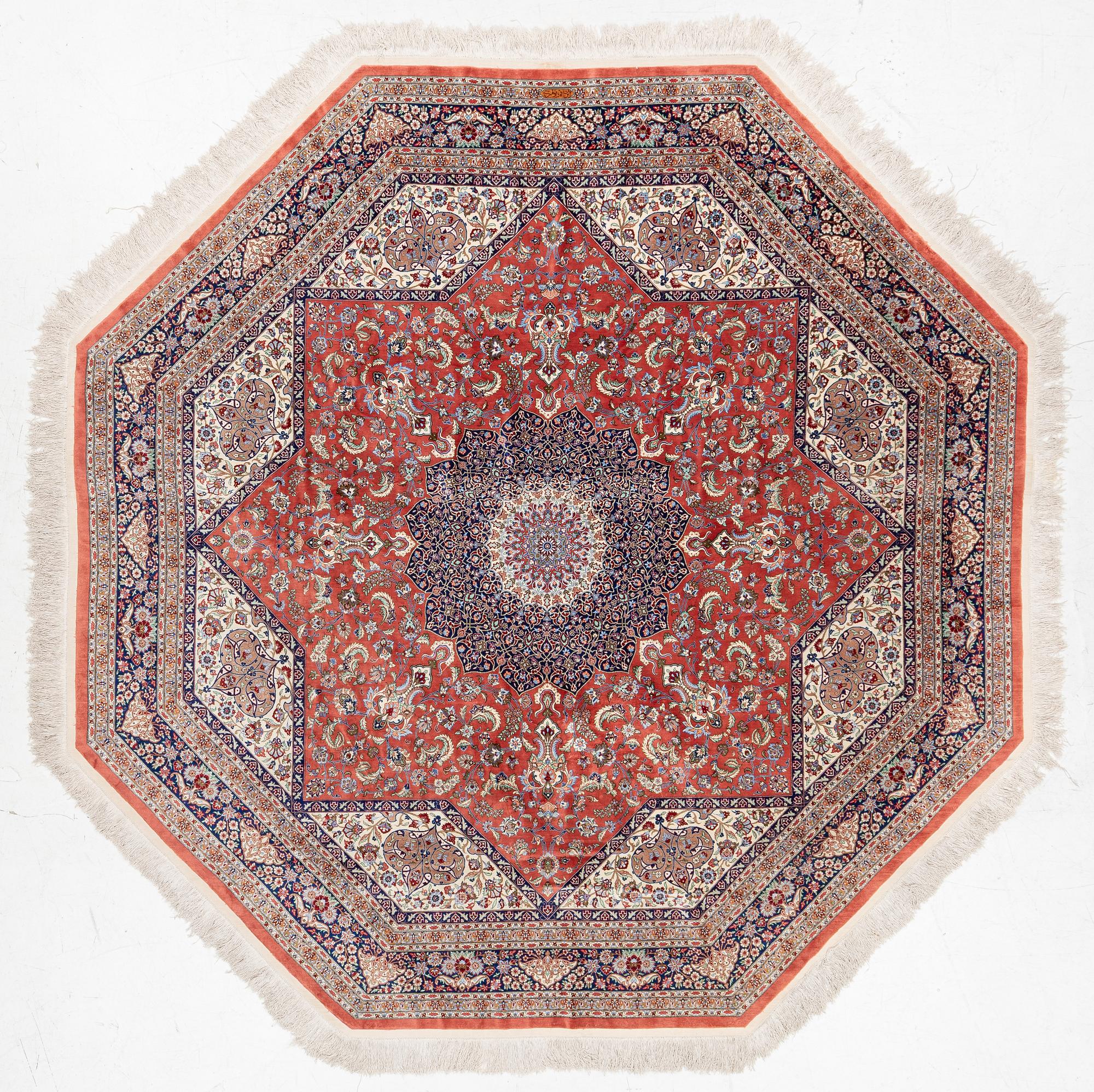 An Oktagonal  silk Qum rug, Central Persia, signed, c. 250 x 250 cm.