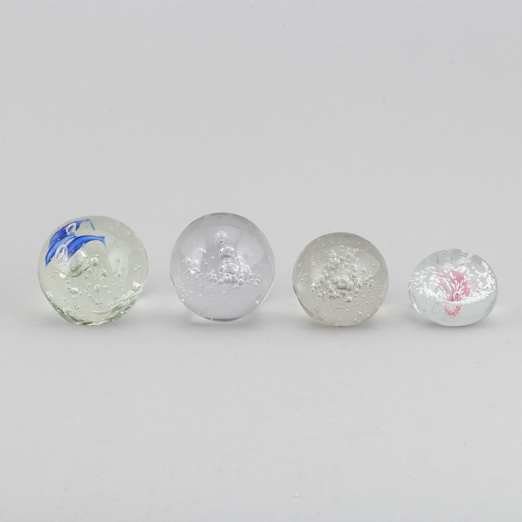 A group of 12 glass paper weights.