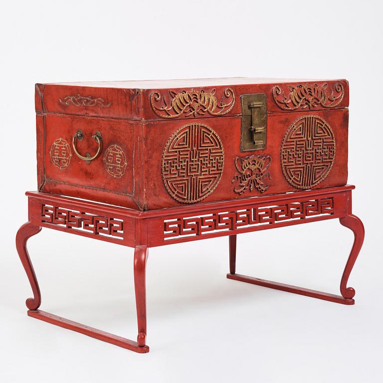 A red lacquered chest on a later stand, late Qing dynasty, 19th Century.