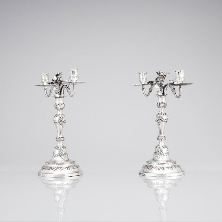 A pair of Swedish 18 century silver candelabras, mark of Lars Åkerblom Gävle 1775, arms by Christian Kullberg.