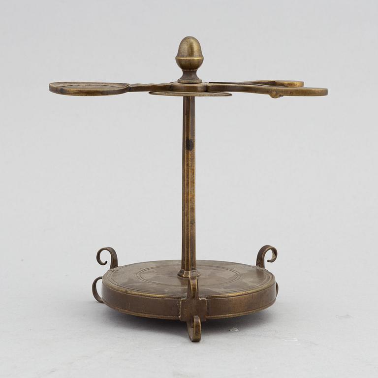 A 18th Century brass candle holder.