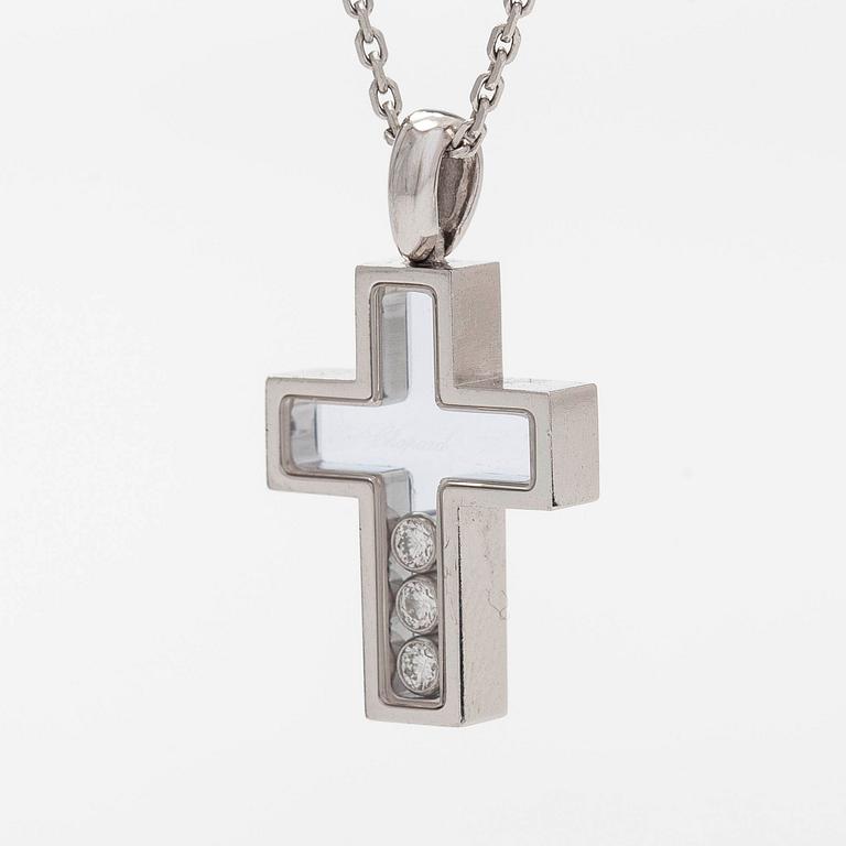 Chopard, an 18K whitegold 'Happy Diamonds" cross necklace set with diamonds.